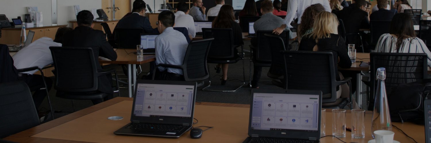 Business professionals attending a corporate training workshop using dell laptops in a conference room with presentation technology