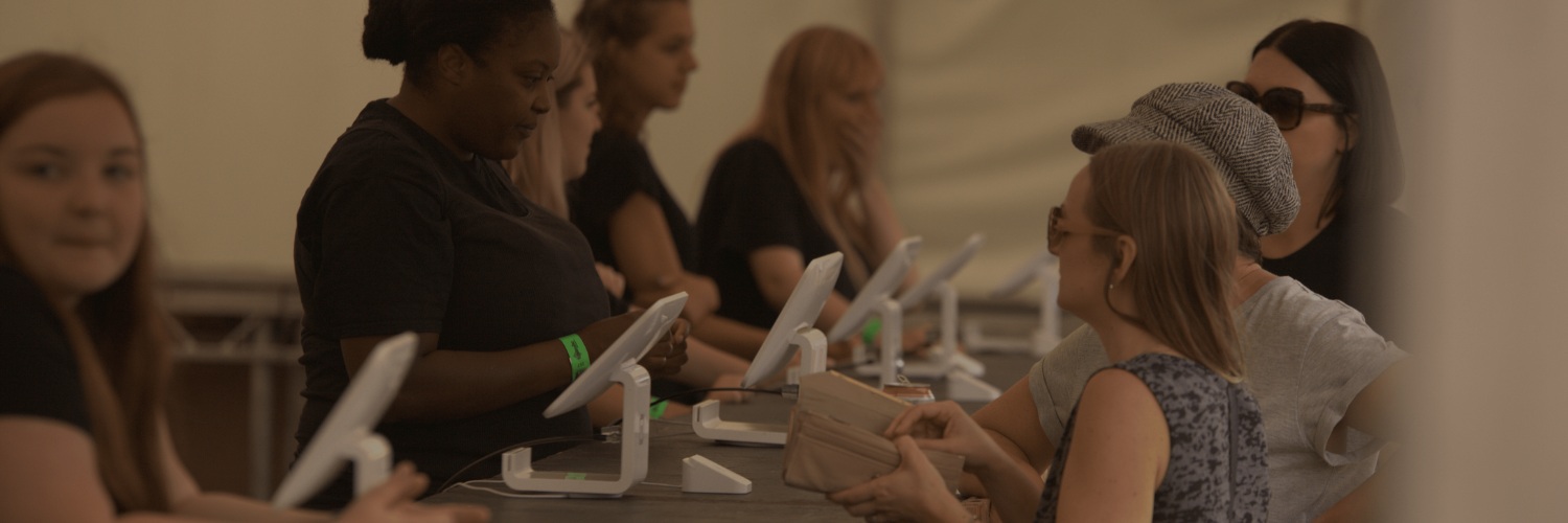 Attendees using tablets during an event registration and check-in session.