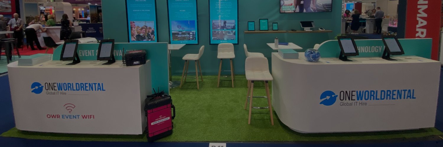 One World Rental event Wi-Fi booth with tablets and portable Wi-Fi equipment at a technology exhibition.